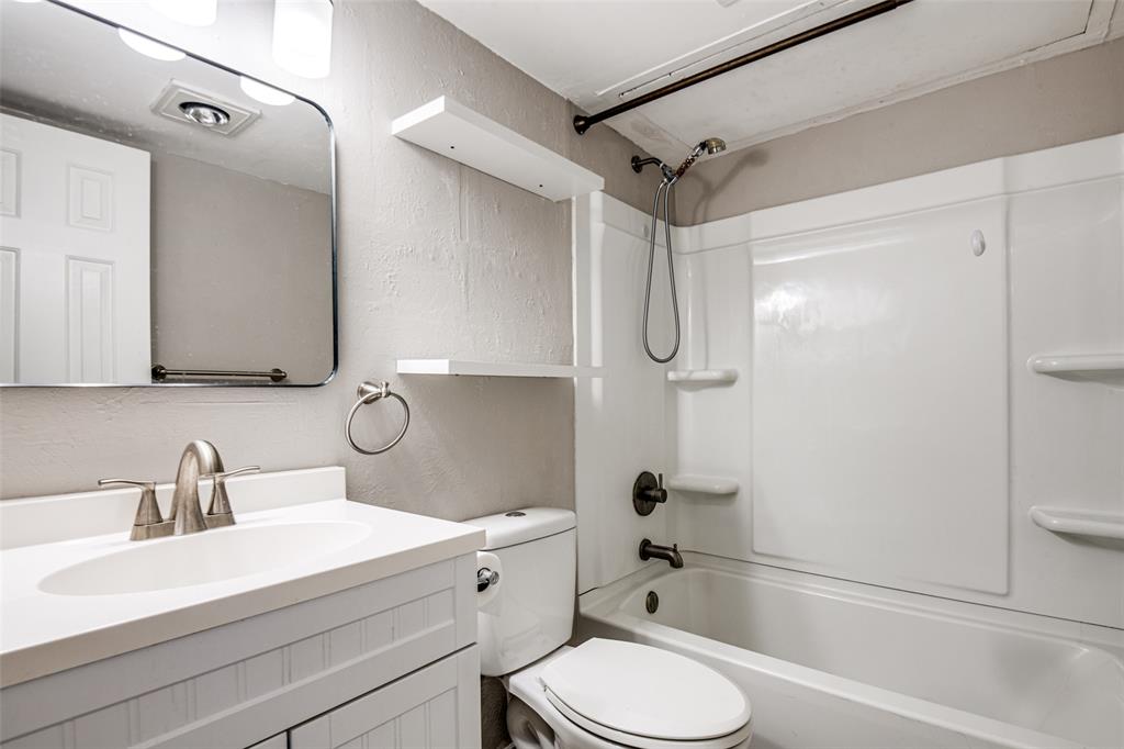 9801 Royal Lane, Unit 711 Dallas, TX 75231 - Photo 20 of 23 a bathroom with a sink toilet and shower