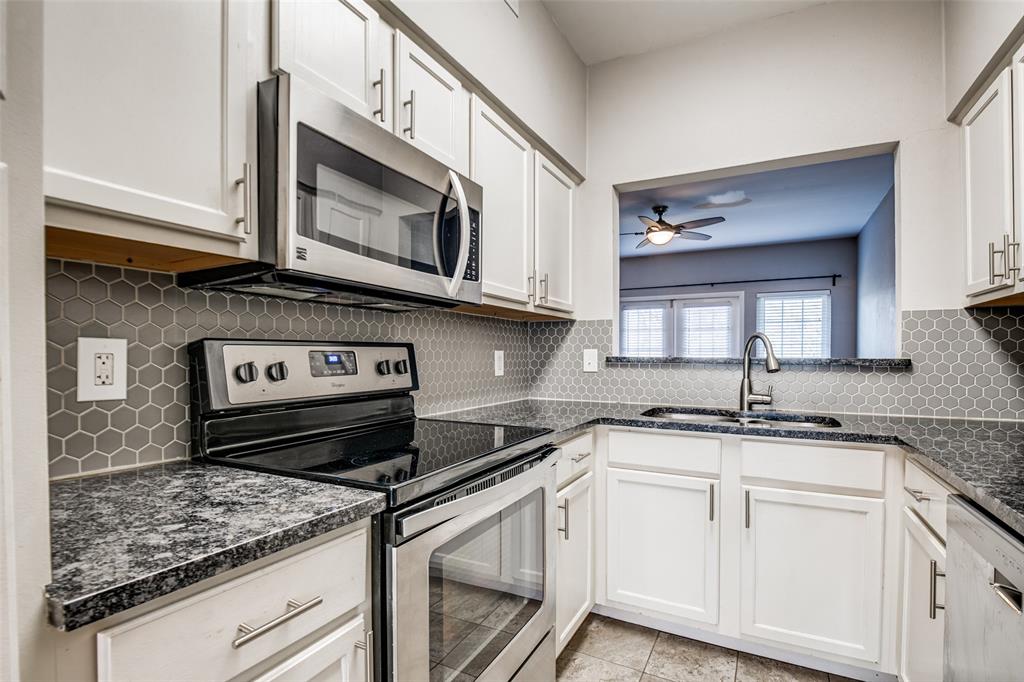 9801 Royal Lane, Unit 711 Dallas, TX 75231 - Photo 6 of 23 a kitchen with stainless steel appliances granite countertop a sink and cabinets