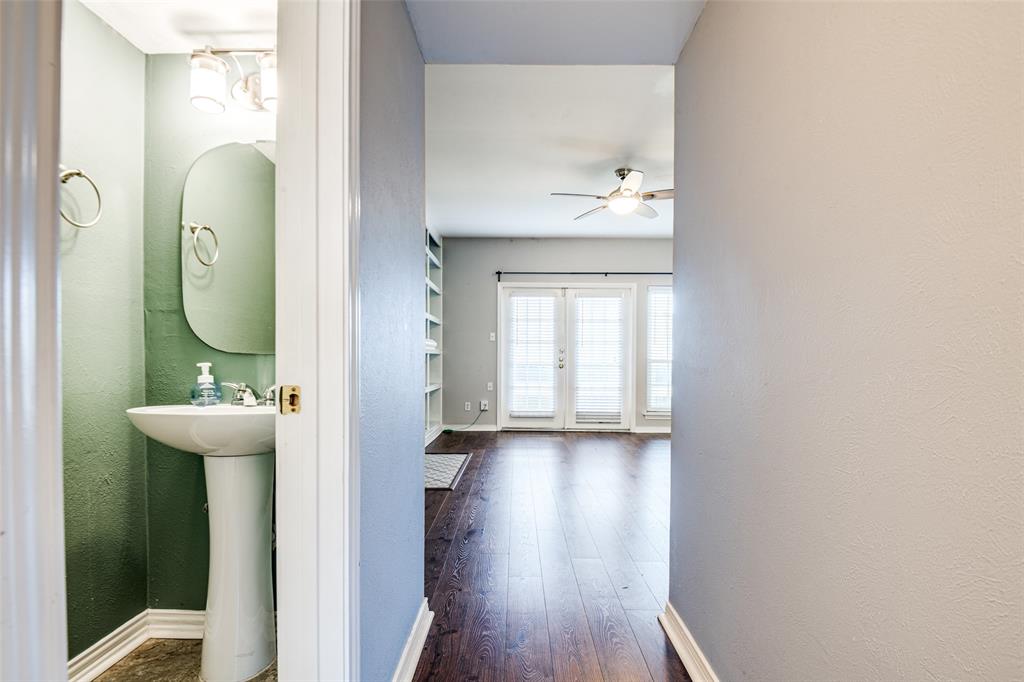 9801 Royal Lane, Unit 711 Dallas, TX 75231 - Photo 7 of 23 a view of a bathroom with a toilet sink mirror and window