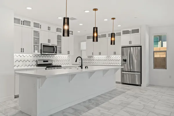 a kitchen with a sink stove and cabinets