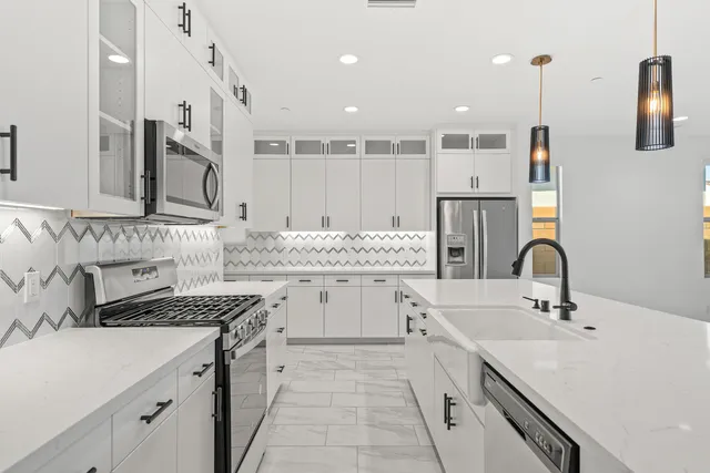 a dining room with furniture potted plants and wooden floor