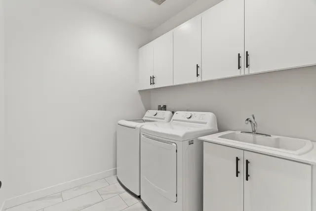 a view of a house with swimming pool lawn chairs and a yard