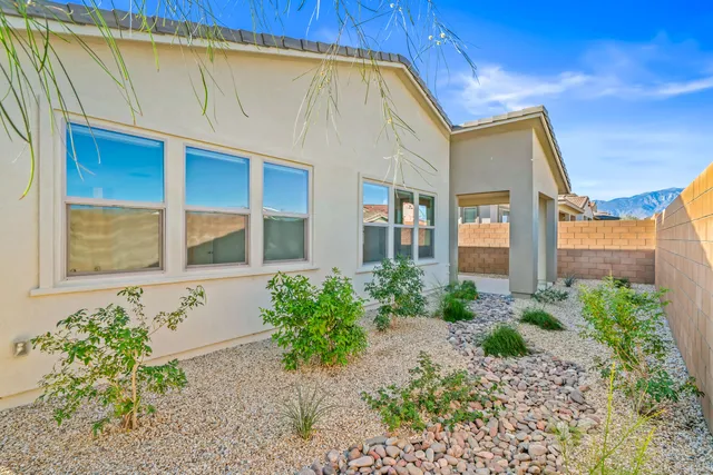 a view of a patio with couches and potted plants