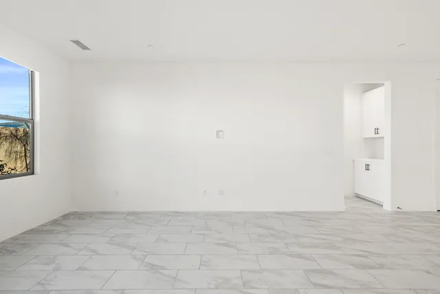 a kitchen with stainless steel appliances granite countertop a refrigerator a oven a sink and white cabinets