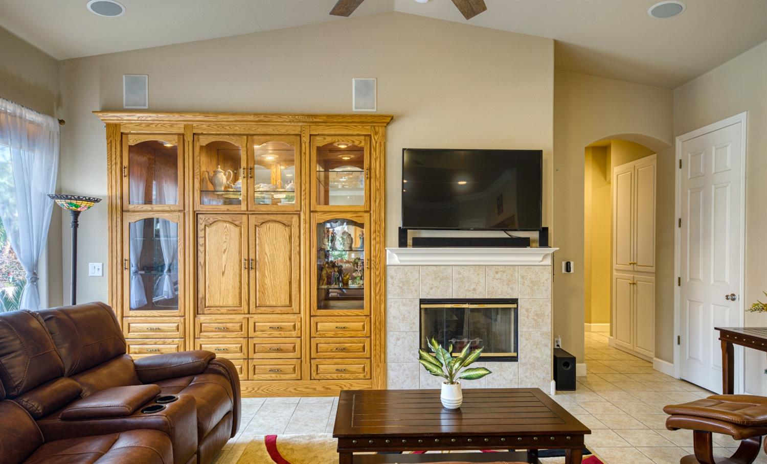 143 West Bedford Avenue Clovis, CA 93611 - Photo 15 of 55 a living room with fireplace furniture and a flat screen tv