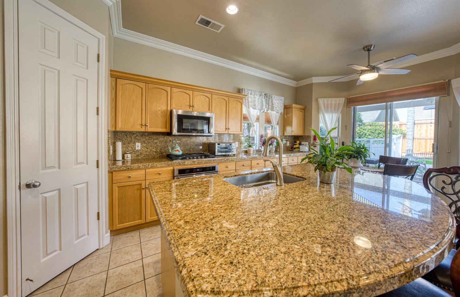 143 West Bedford Avenue Clovis, CA 93611 - Photo 18 of 55 a living room with stainless steel appliances granite countertop furniture a fireplace a flat screen tv and a window