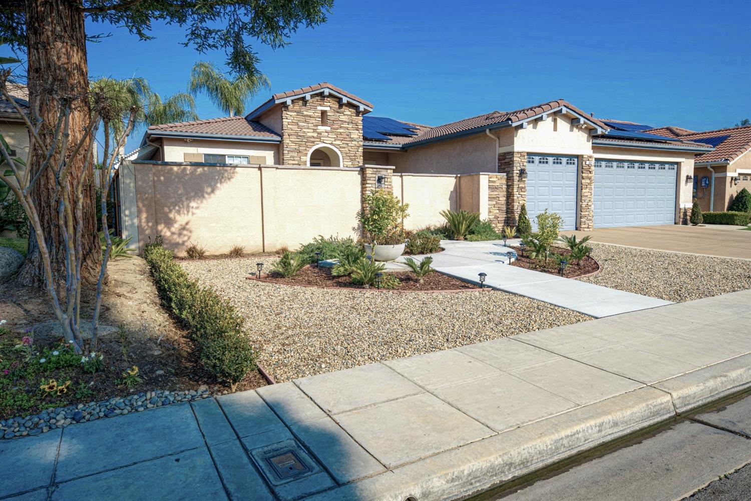 143 West Bedford Avenue Clovis, CA 93611 - Photo 2 of 55 a front view of a house with garden