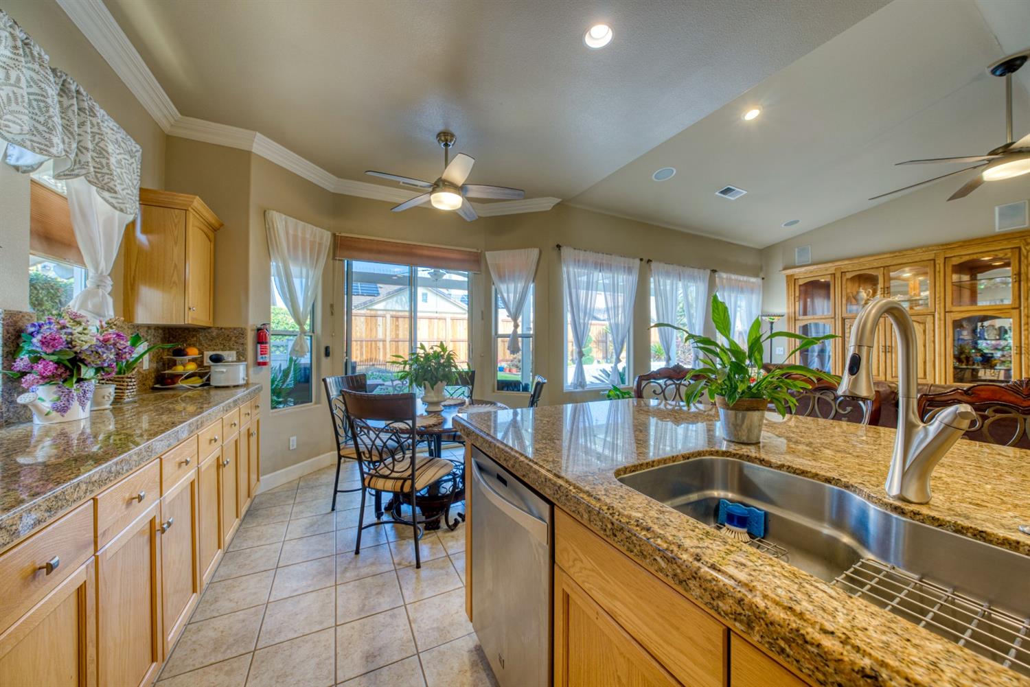143 West Bedford Avenue Clovis, CA 93611 - Photo 22 of 55 a kitchen with stainless steel appliances granite countertop sink stove and cabinets