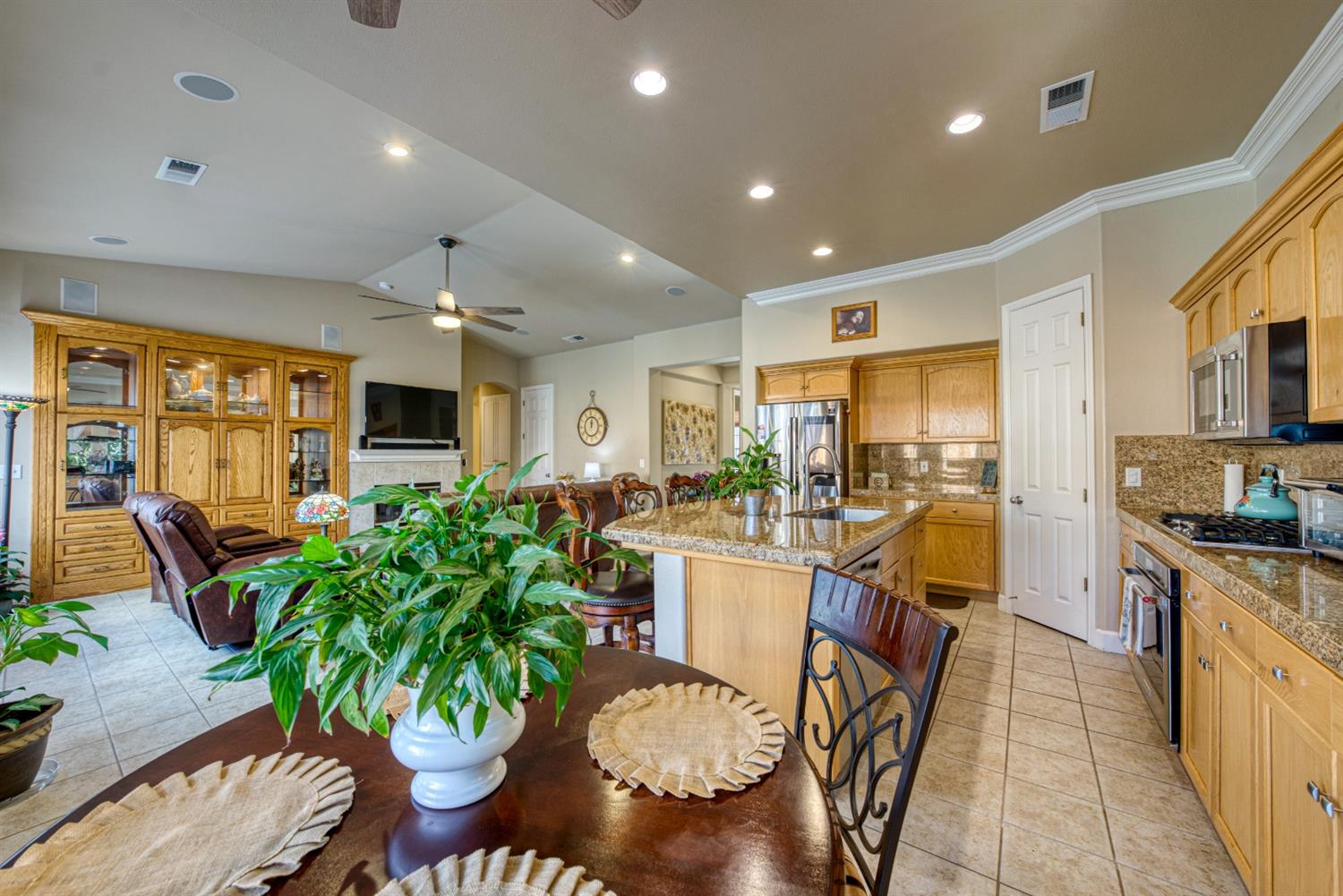 143 West Bedford Avenue Clovis, CA 93611 - Photo 24 of 55 a living room filled with furniture potted plant and kitchen view