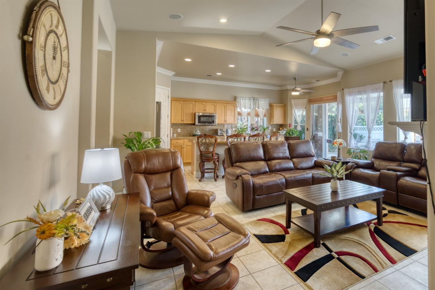 143 West Bedford Avenue Clovis, CA 93611 - Photo 25 of 55 a living room with furniture a chandelier fan and a rug