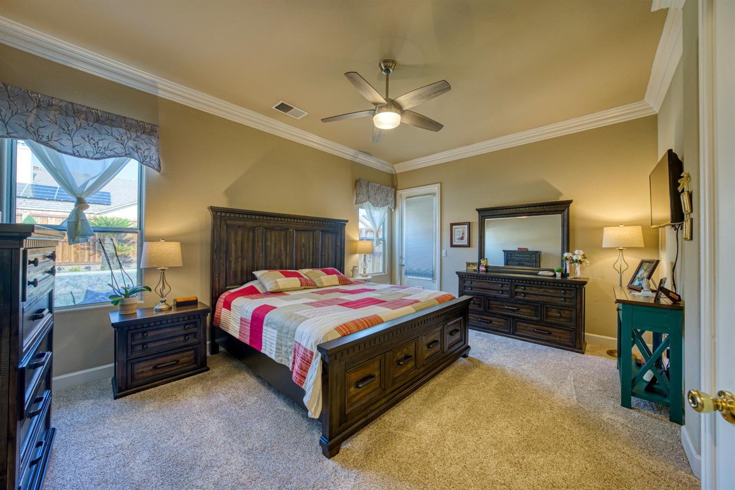 143 West Bedford Avenue Clovis, CA 93611 - Photo 27 of 55 a spacious bedroom with a bed and a chandelier