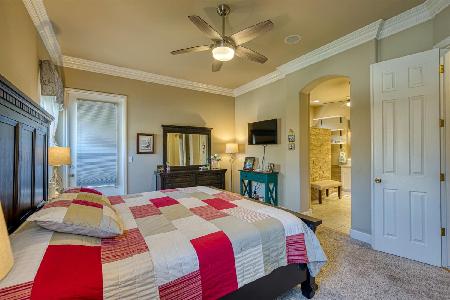 143 West Bedford Avenue Clovis, CA 93611 - Photo 28 of 55 a bedroom with a bed and a chandelier