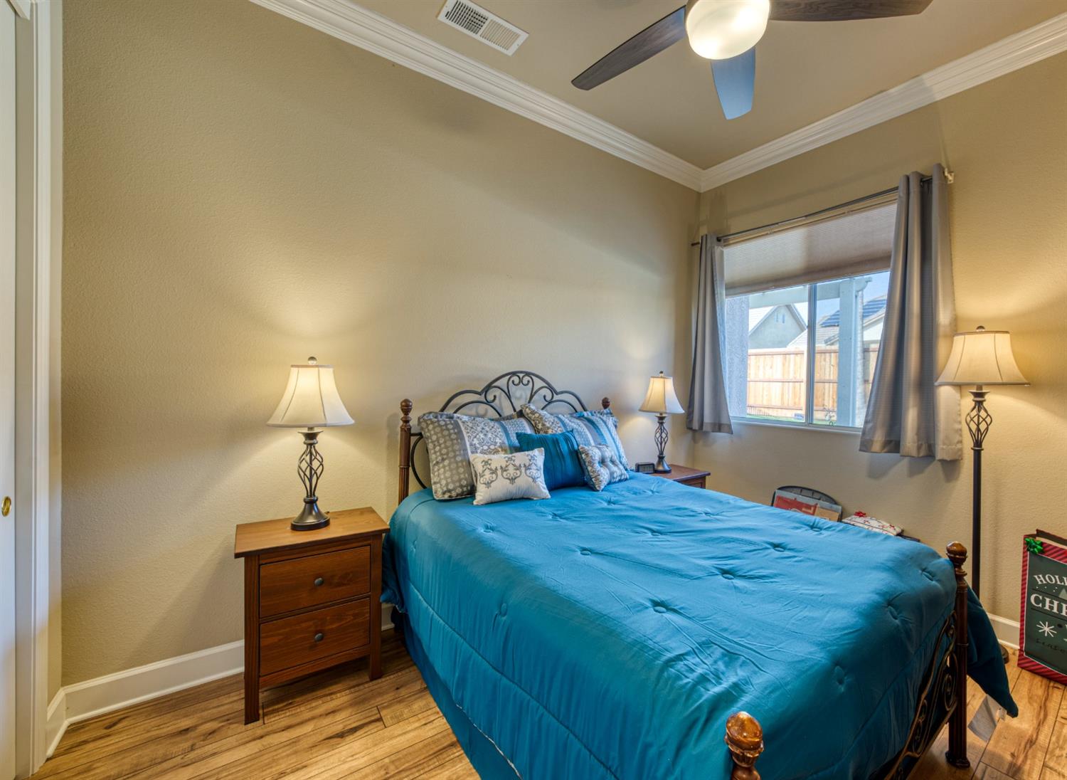 143 West Bedford Avenue Clovis, CA 93611 - Photo 36 of 55 a bedroom with a bed and a lamp on table