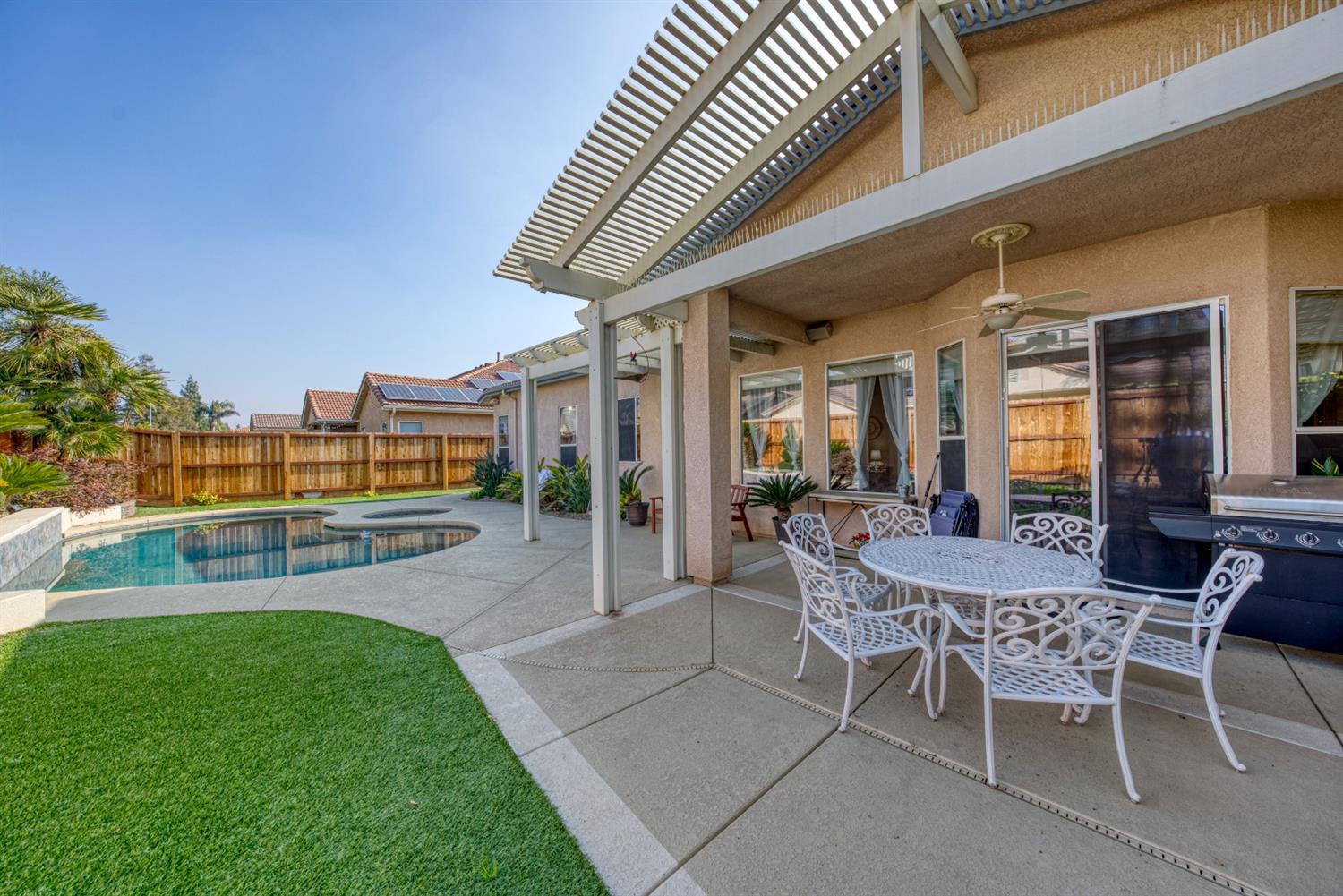 143 West Bedford Avenue Clovis, CA 93611 - Photo 48 of 55 a view of a backyard with a patio and outdoor seating