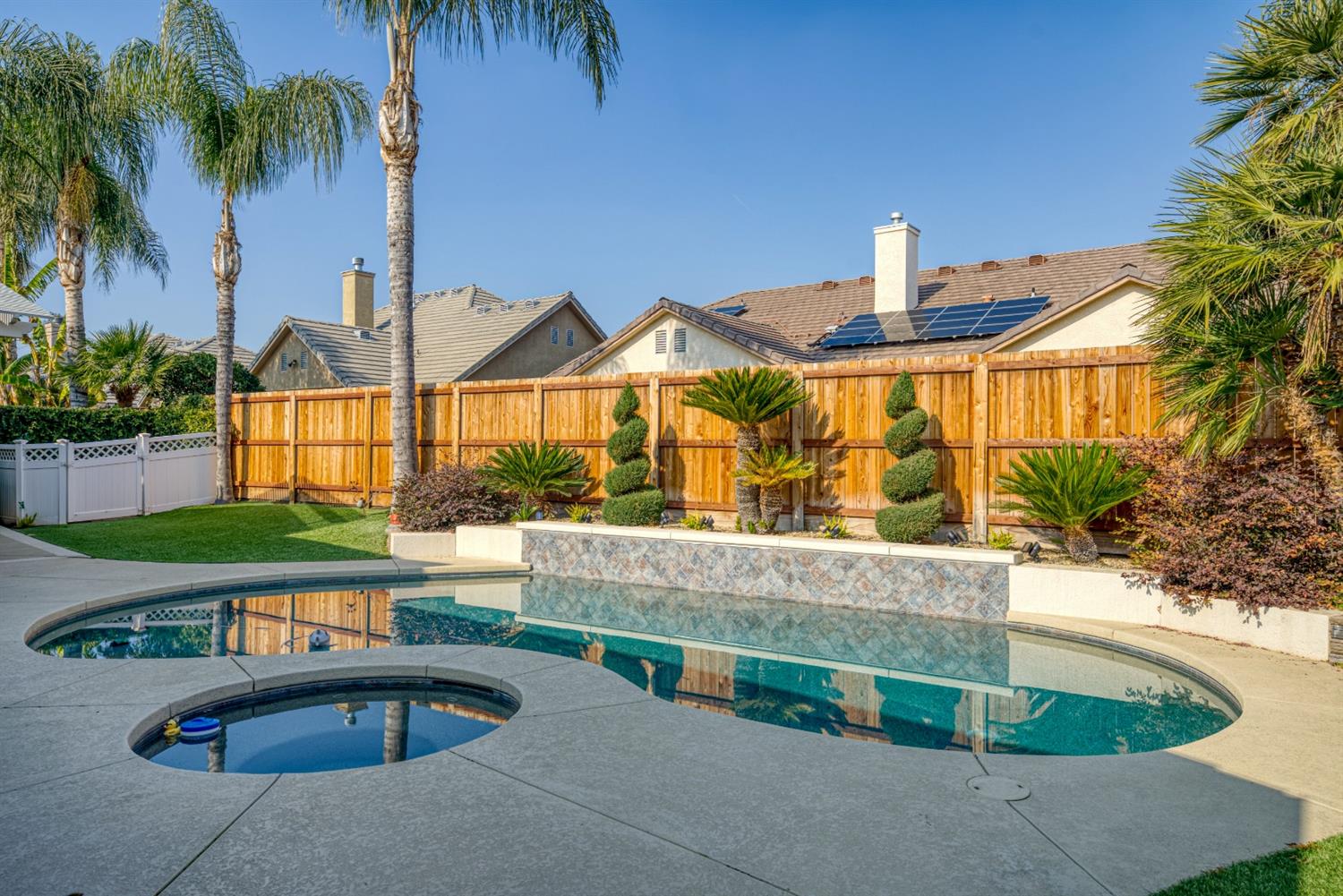 143 West Bedford Avenue Clovis, CA 93611 - Photo 51 of 55 a front view of a house with swimming pool