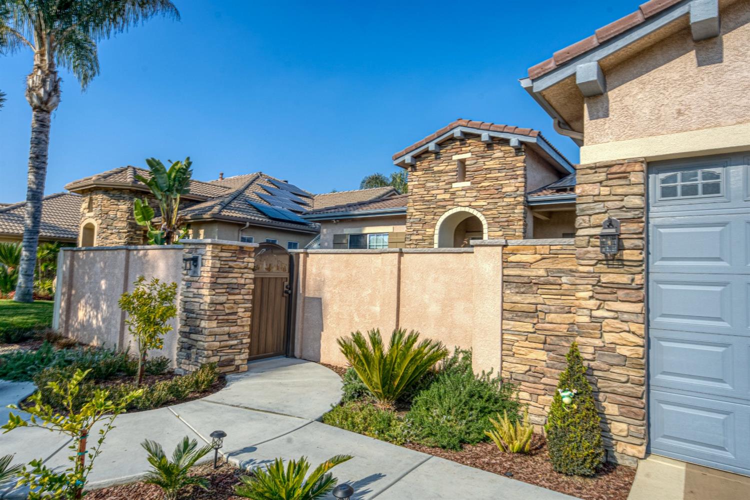 143 West Bedford Avenue Clovis, CA 93611 - Photo 55 of 55 a front view of a house with a garden