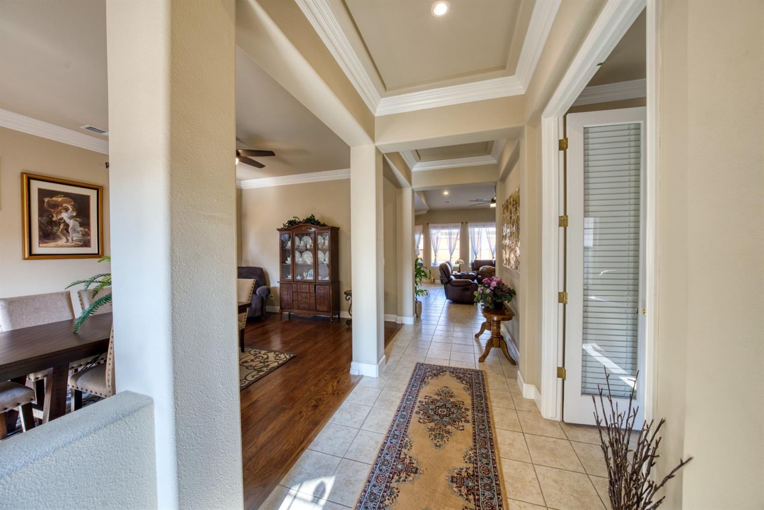 143 West Bedford Avenue Clovis, CA 93611 - Photo 9 of 55 a view of a hallway with wooden floor and a bedroom
