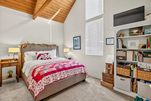 a bedroom with a bed and a book shelf