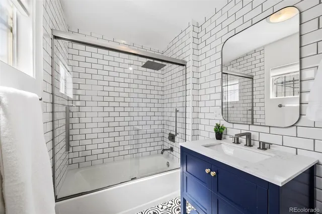 a bathroom with a sink mirror toilet and bathtub