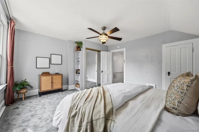 a bedroom with a bed and a couch