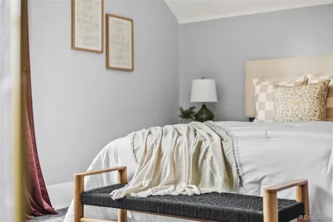 a bedroom with a bed and a lamp