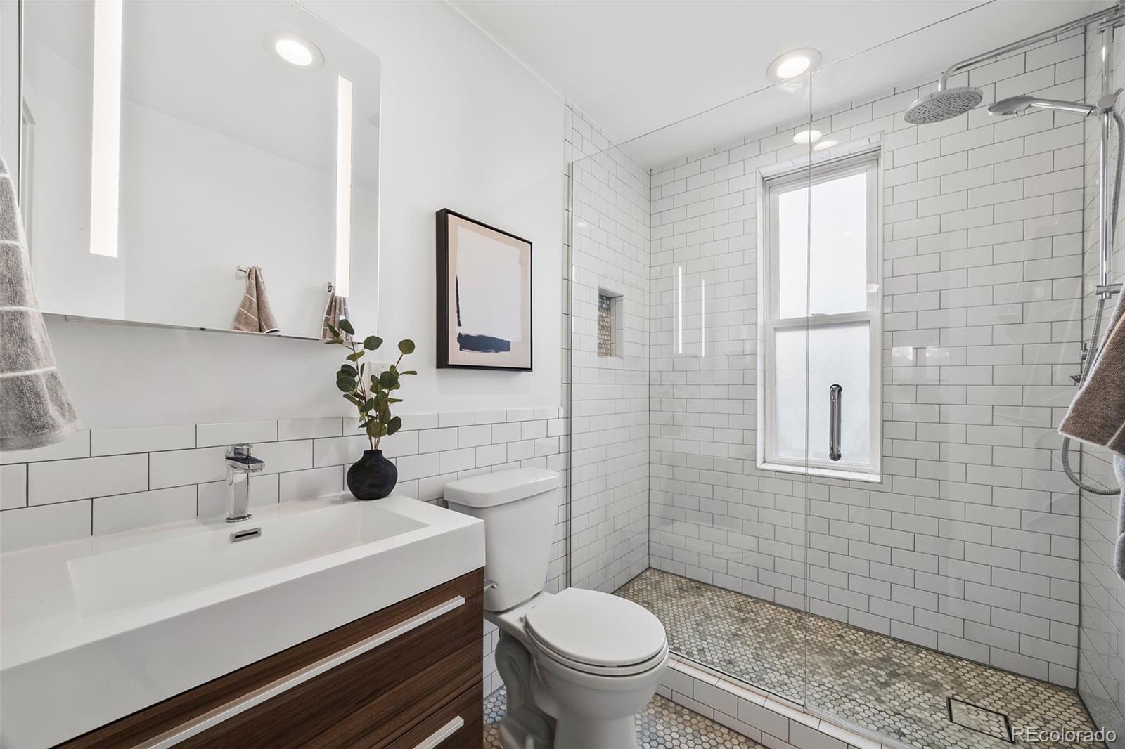 35 West Byers Place Denver, CO 80223 - Photo 19 of 31 a bathroom with a sink a toilet and shower