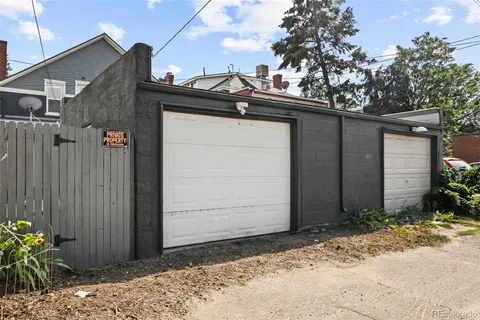 a side view of a house with a tree