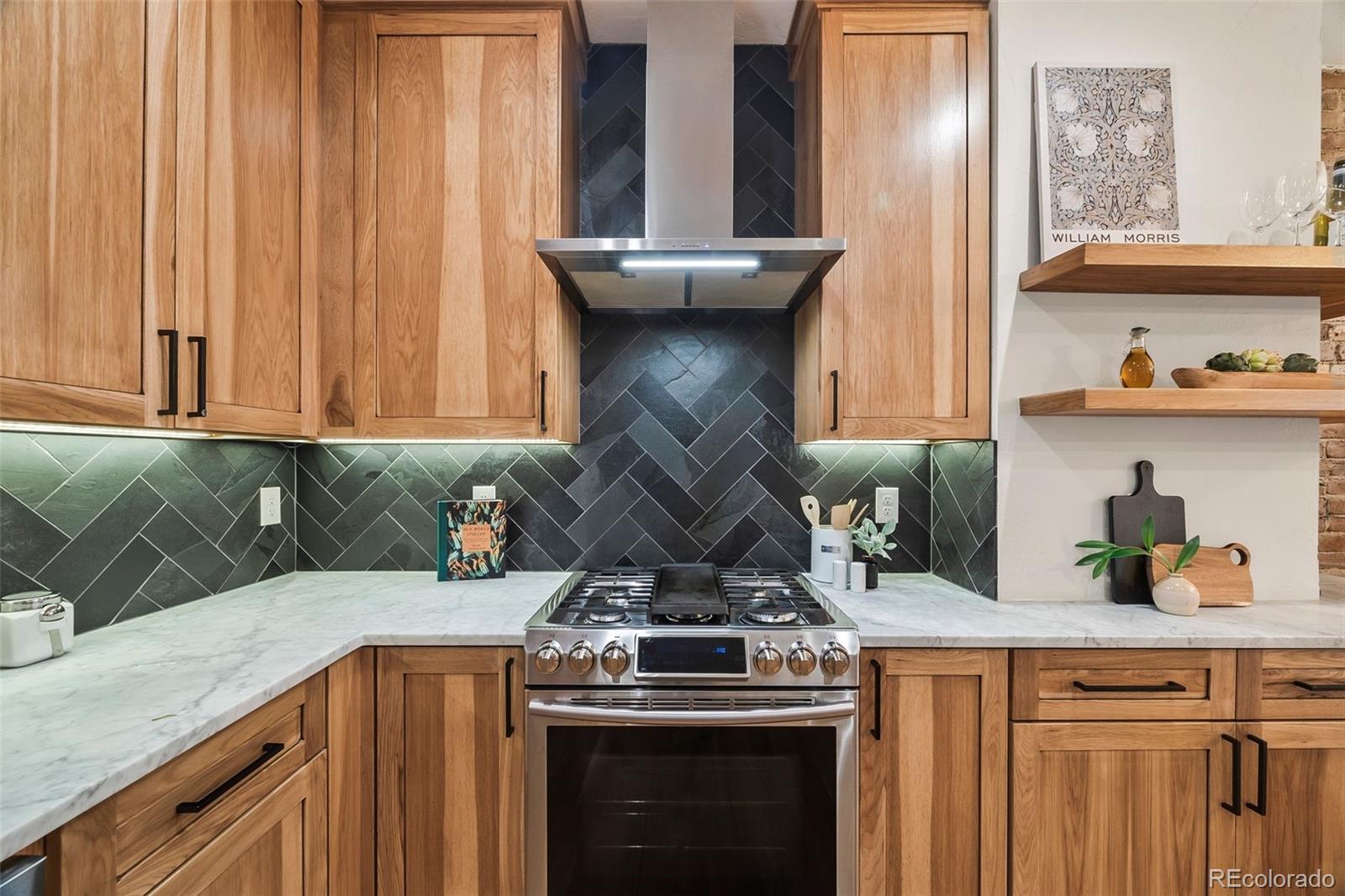 35 West Byers Place Denver, CO 80223 - Photo 9 of 31 a kitchen with a stove and cabinets
