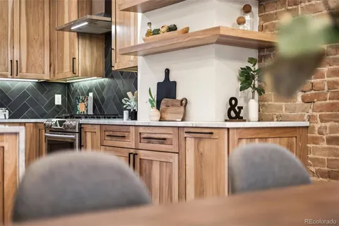 a kitchen view with table and chairs in it