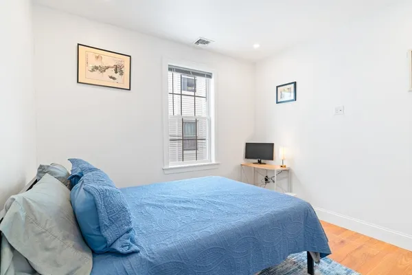 a bedroom with a bed and a tv