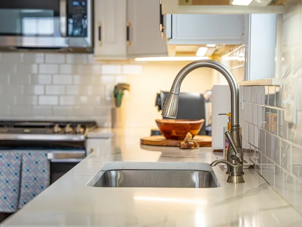 a kitchen with a sink a counter and a stove top oven