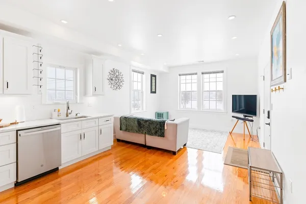 a spacious bedroom with a bed and a flat screen tv