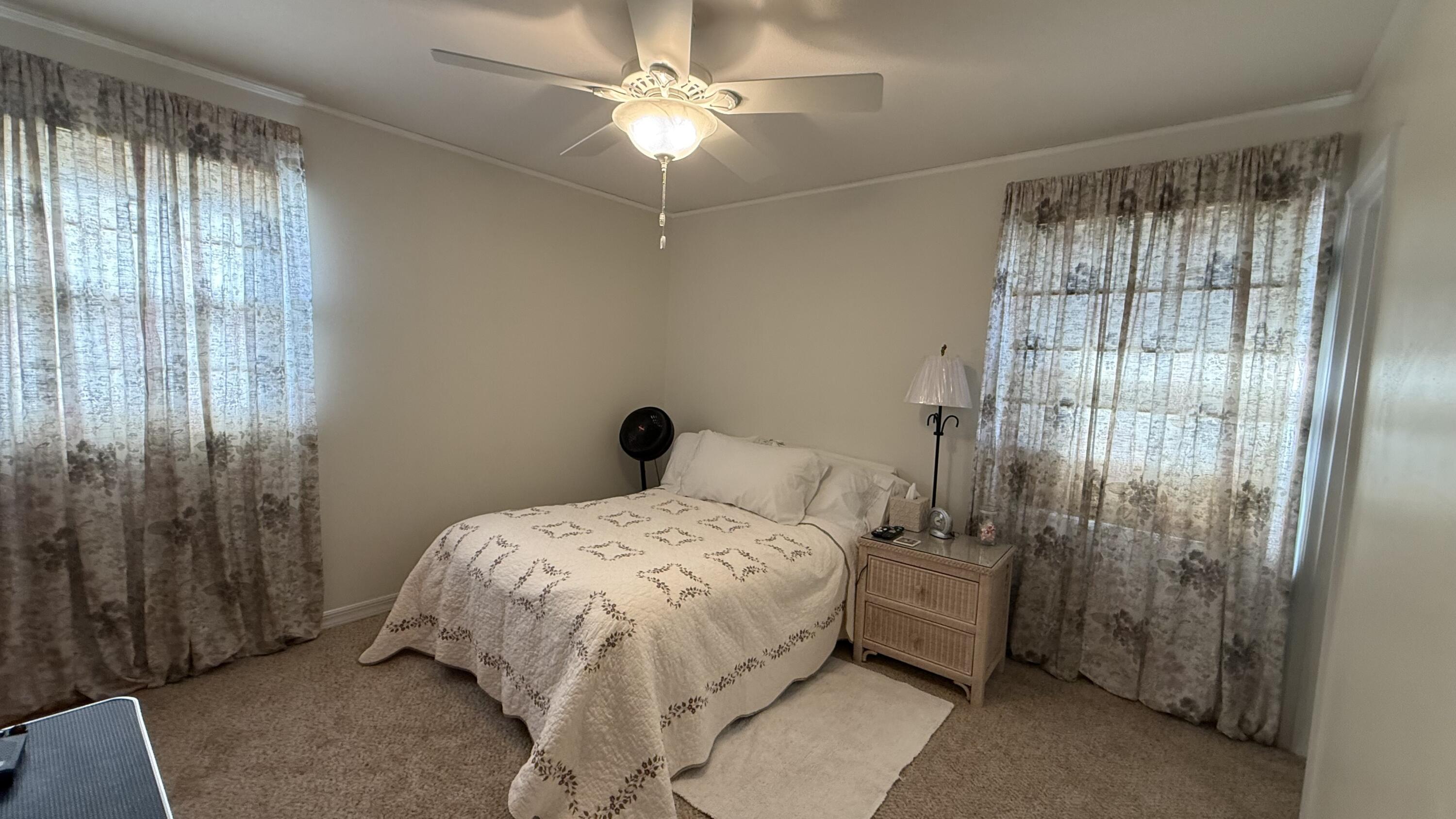 238 Martisa Road Northwest Fort Walton Beach, FL 32548 - Photo 12 of 48 a bedroom with a bed and a chandelier