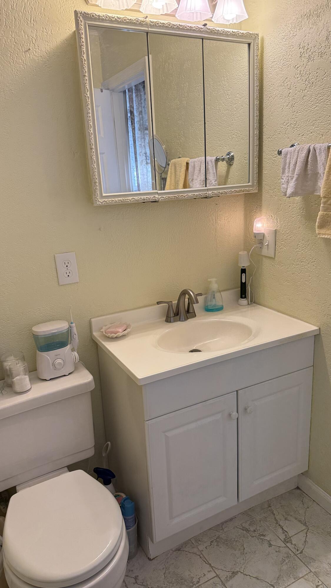 238 Martisa Road Northwest Fort Walton Beach, FL 32548 - Photo 15 of 48 a bathroom with a sink a toilet and mirror