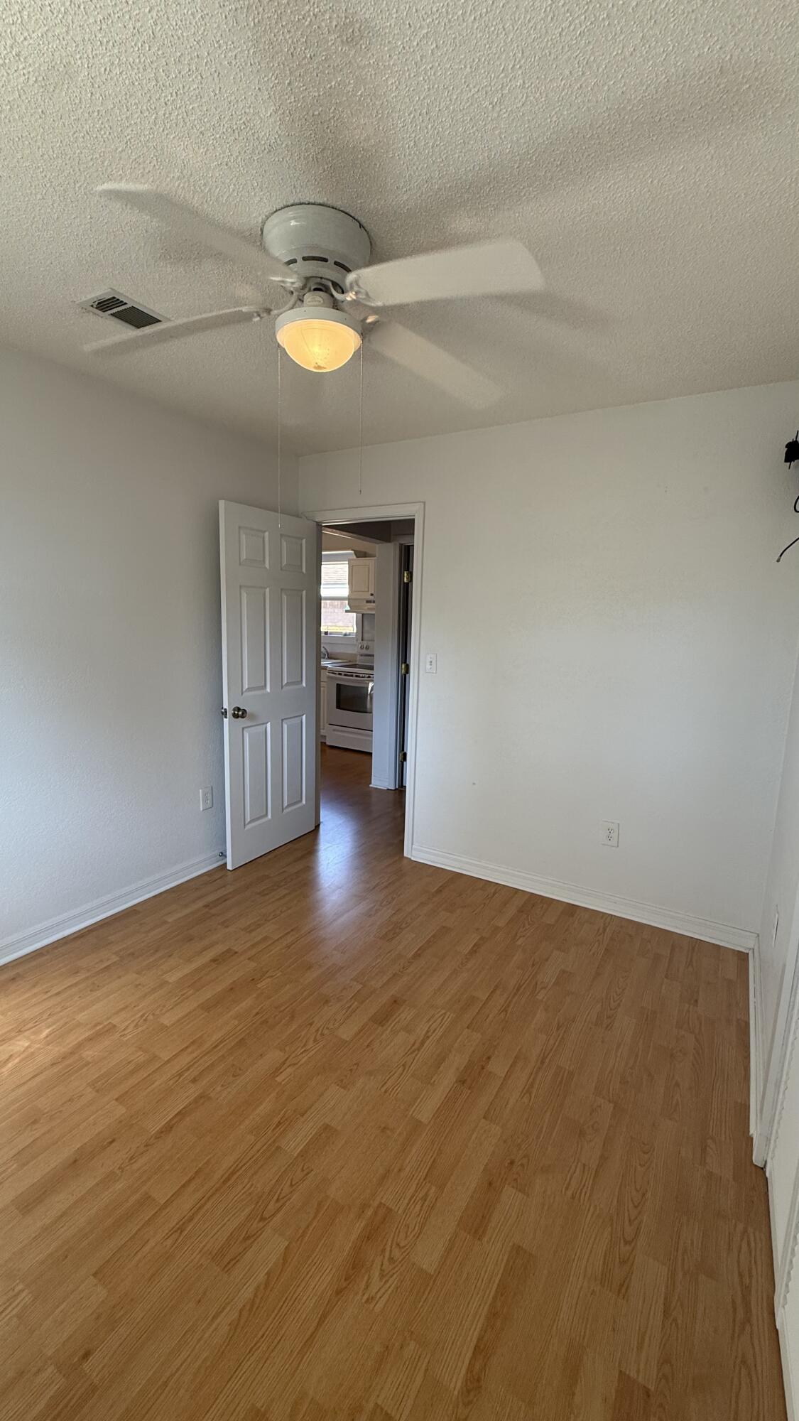 238 Martisa Road Northwest Fort Walton Beach, FL 32548 - Photo 41 of 48 a view of empty room with wooden floor and fan