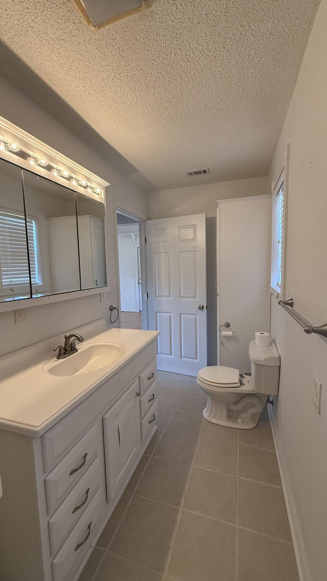 238 Martisa Road Northwest Fort Walton Beach, FL 32548 - Photo 42 of 48 a spacious bathroom with a double vanity sink and a mirror