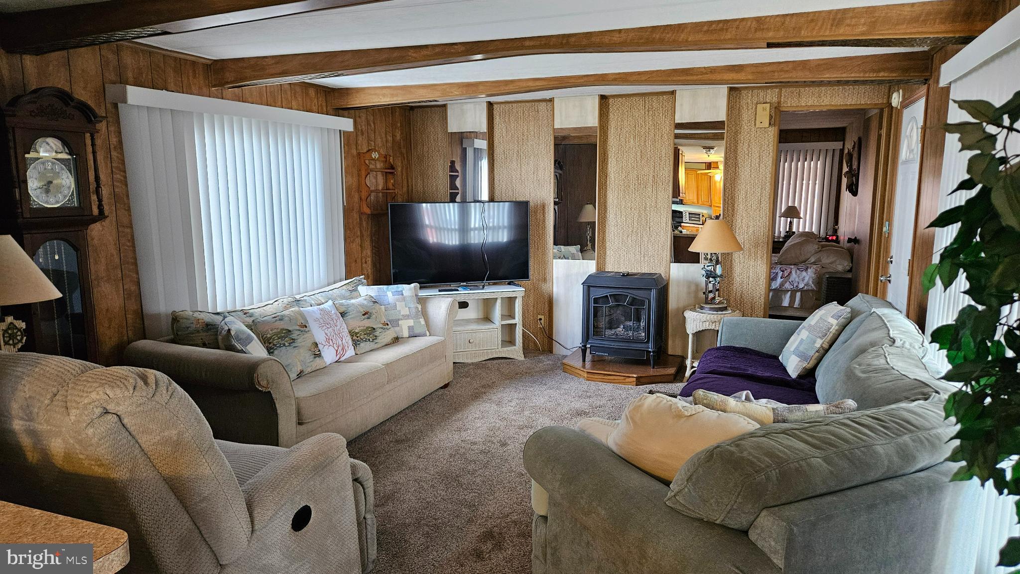 37032 Laws Point Road, Unit 37032 Selbyville, DE 19975 - Photo 3 of 7 a living room with furniture and a flat screen tv