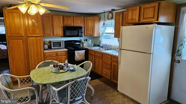 a kitchen with stainless steel appliances granite countertop a refrigerator a microwave a sink and a stove