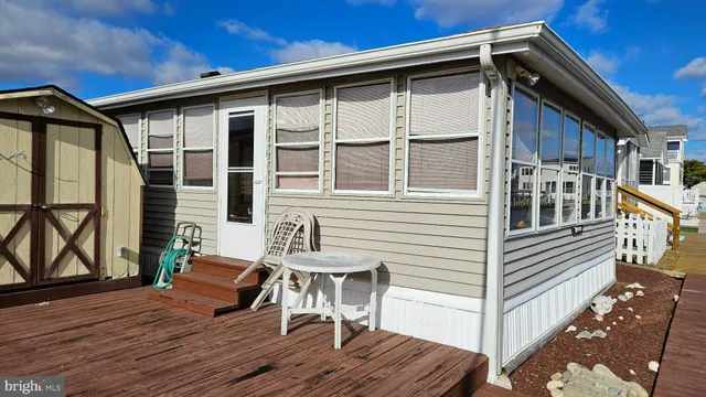 a view of deck with table and chairs with wooden floor and fence