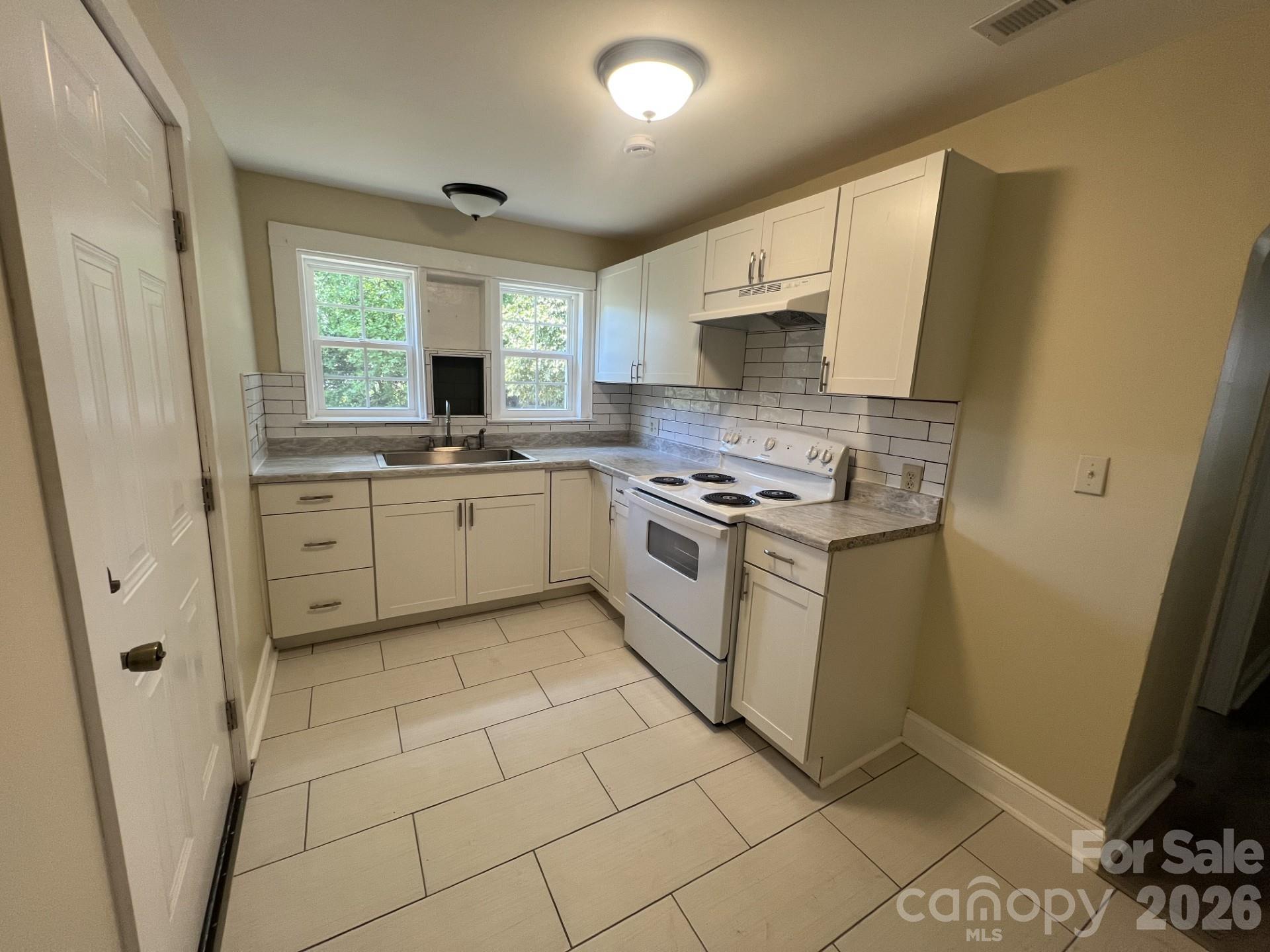 511 Murphy Street Kannapolis, NC 28081 - Photo 13 of 23 a kitchen with a stove a sink and a refrigerator
