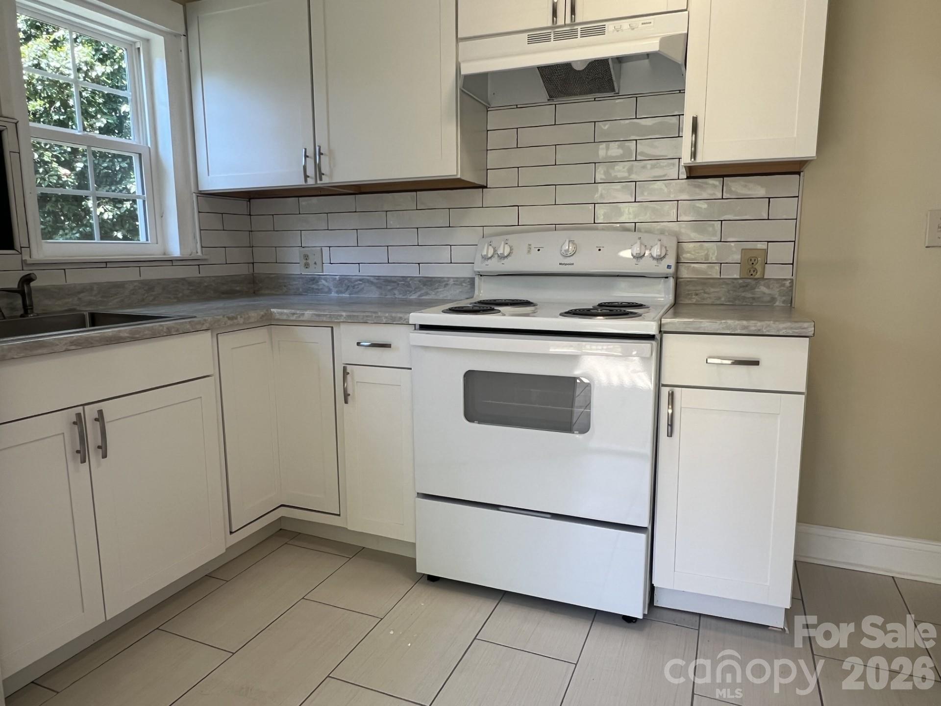 511 Murphy Street Kannapolis, NC 28081 - Photo 15 of 23 a kitchen with granite countertop white cabinets and white appliances