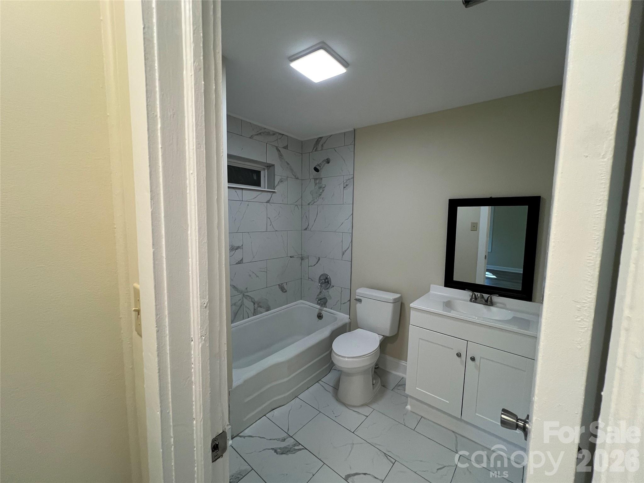511 Murphy Street Kannapolis, NC 28081 - Photo 21 of 23 a bathroom with a granite countertop toilet a sink and a bathtub