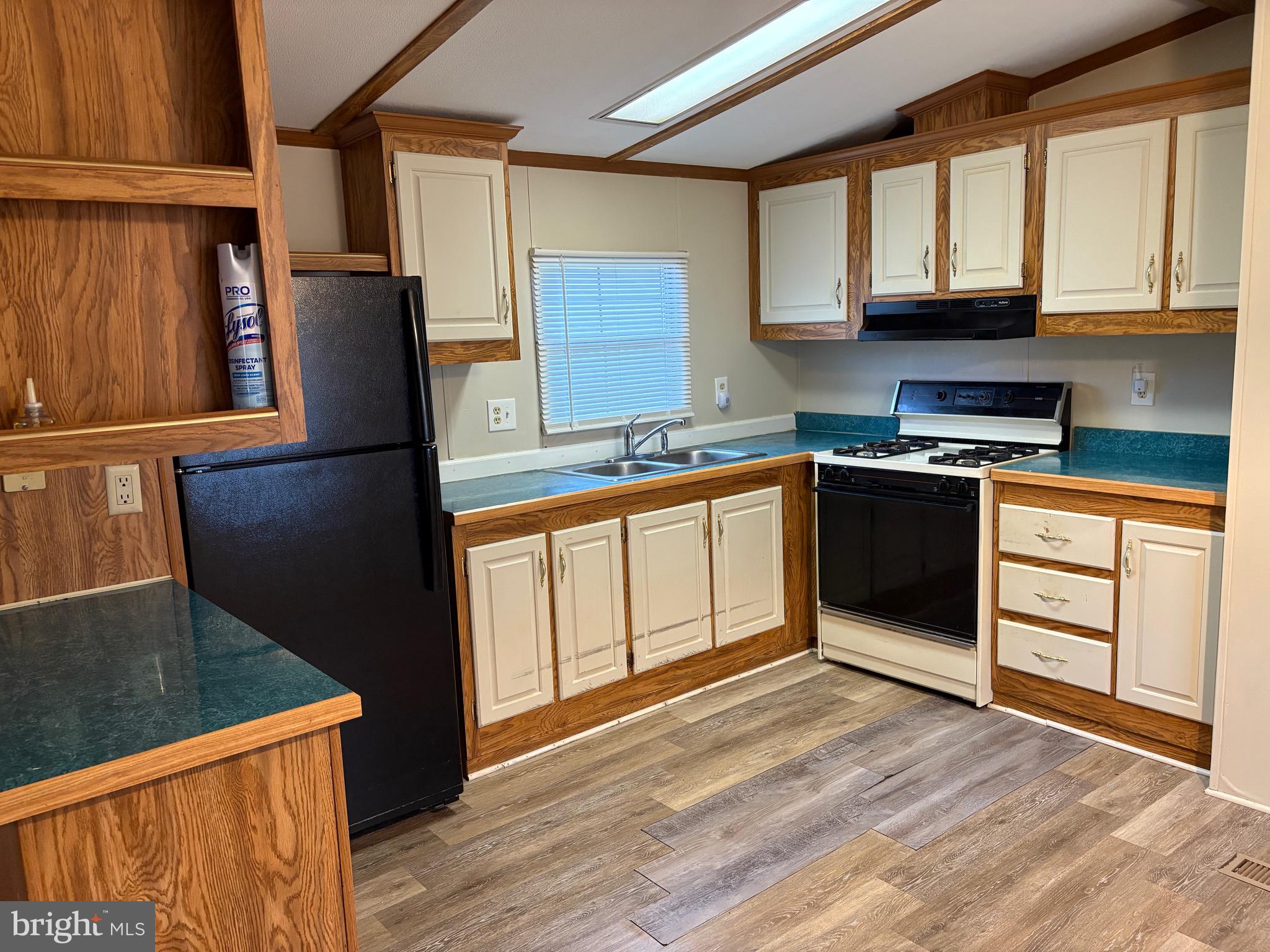 1021 Barberry Avenue, Unit T67 Reading, PA 19605 - Photo 3 of 10 a kitchen with stainless steel appliances granite countertop a refrigerator a sink dishwasher and wooden cabinets with wooden floor