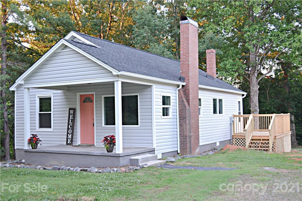 6814 Jenkins Road Morganton, NC 28655 - Photo 1 of 14 a front view of a house with garden