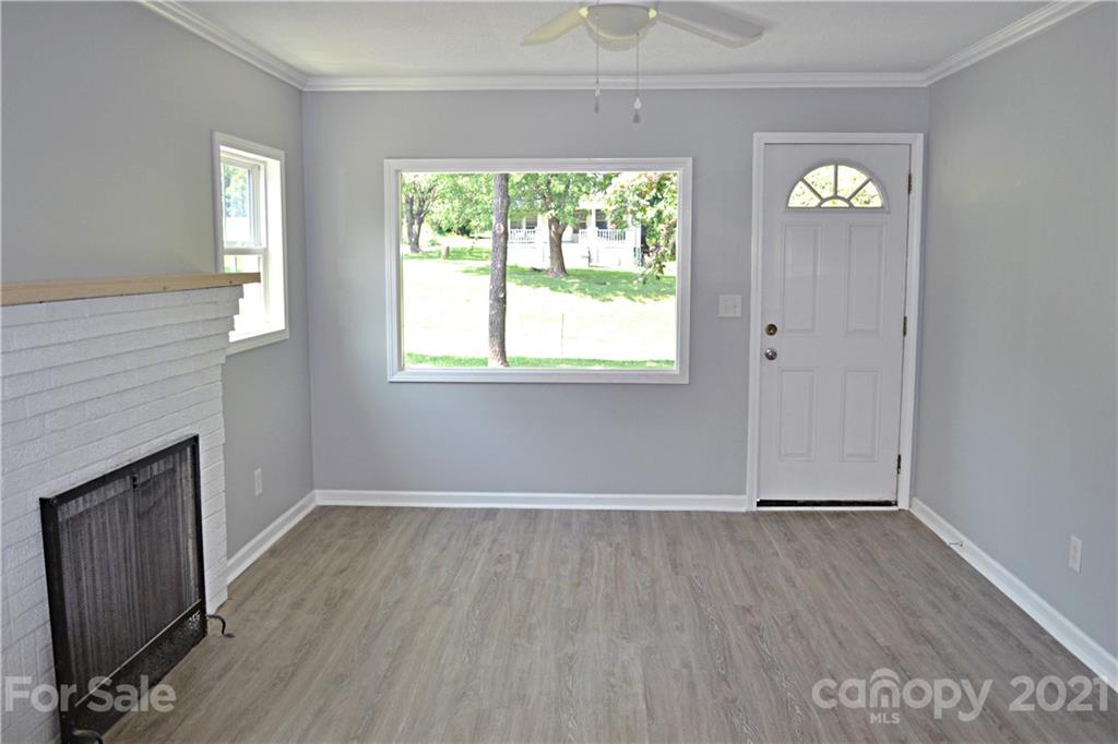 6814 Jenkins Road Morganton, NC 28655 - Photo 4 of 14 an empty room with wooden floor and windows