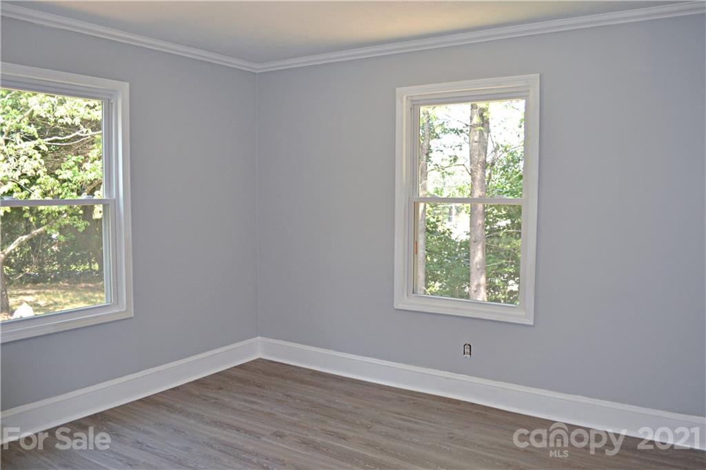 6814 Jenkins Road Morganton, NC 28655 - Photo 5 of 14 a view of an empty room with wooden floor and a window