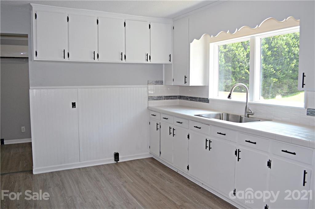6814 Jenkins Road Morganton, NC 28655 - Photo 7 of 14 a view of cabinets with wooden floor