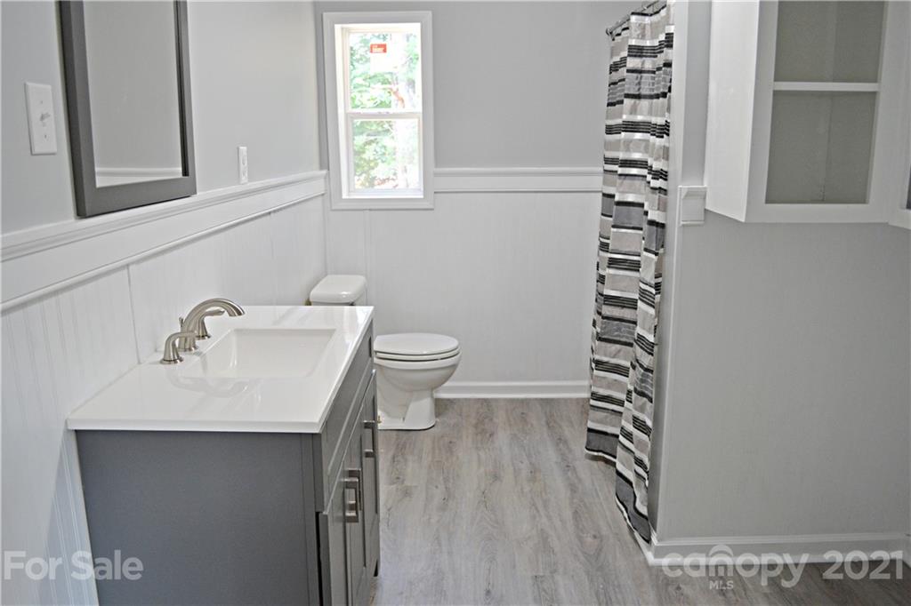 6814 Jenkins Road Morganton, NC 28655 - Photo 8 of 14 a bathroom with a sink a toilet and a window