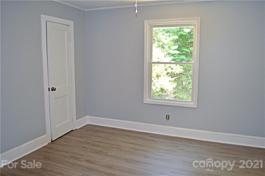 6814 Jenkins Road Morganton, NC 28655 - Photo 9 of 14 a view of an empty room with wooden floor and a window