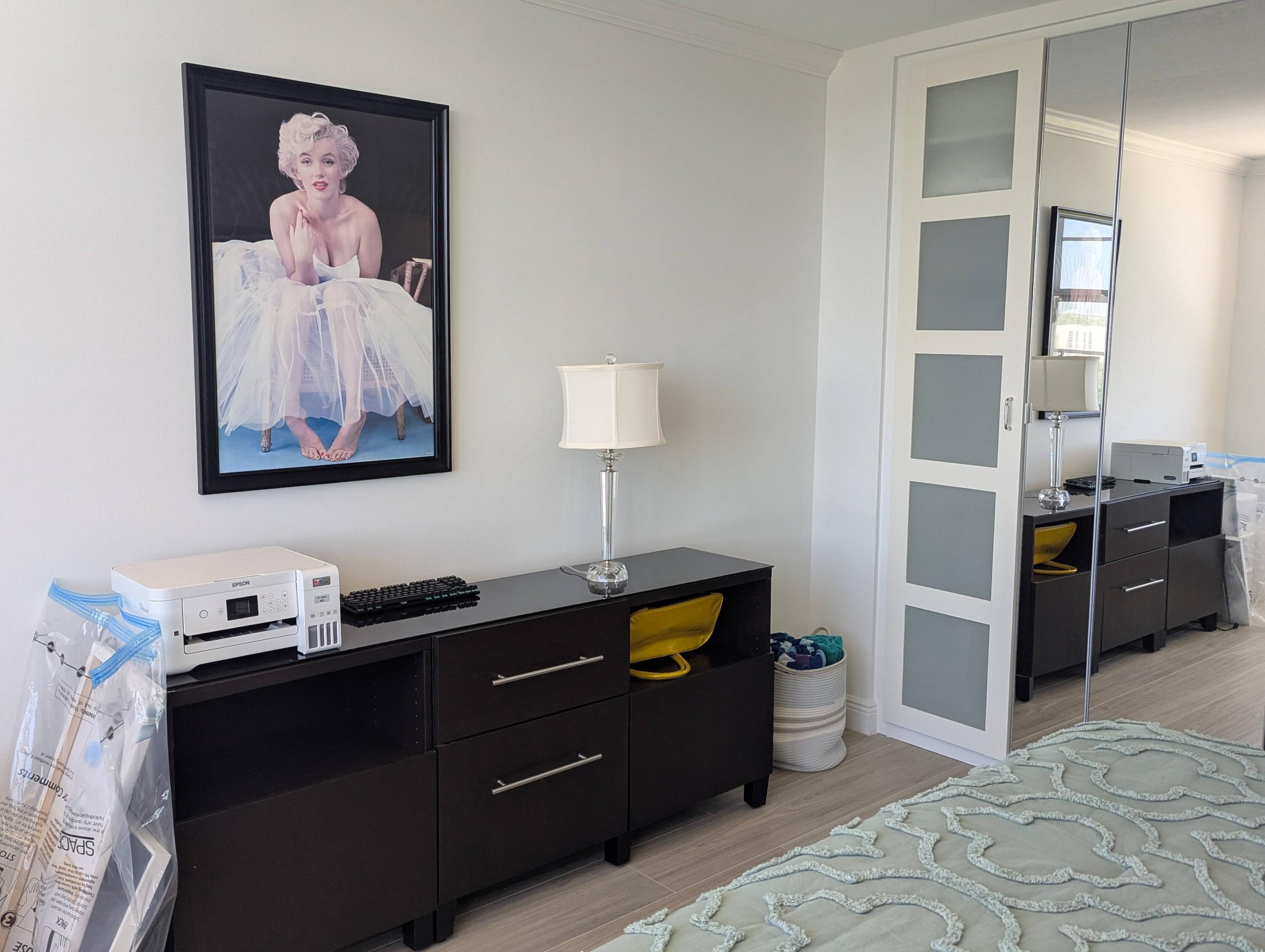 2121 North Ocean Boulevard, Unit 1006E Boca Raton, FL 33431 - Photo 41 of 64 a bedroom with a bed and a lamp on dresser